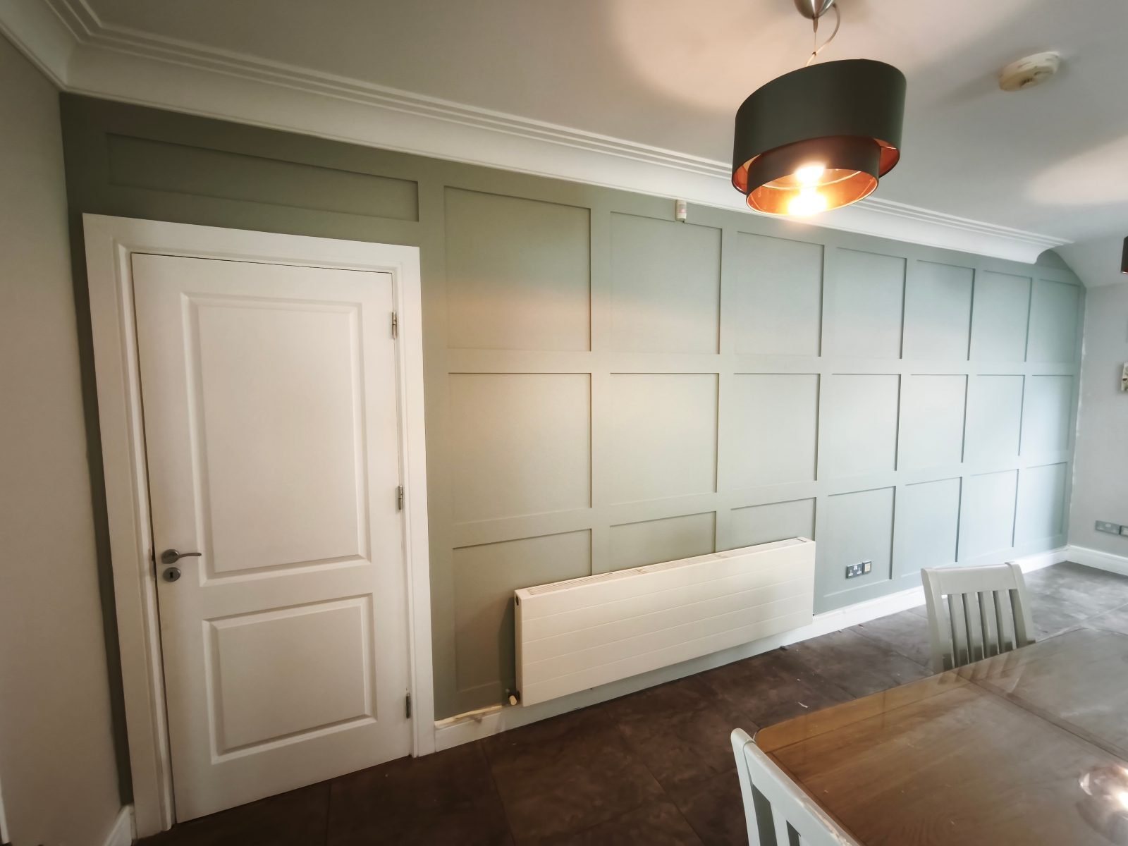Sage panelling around a door